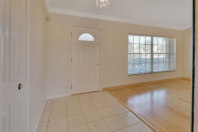 entrance foyer featuring ornamental molding, plenty of natural light, and light wood-type flooring