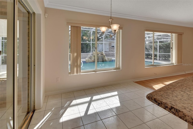 unfurnished dining area with light tile patterned flooring, crown molding, and an inviting chandelier