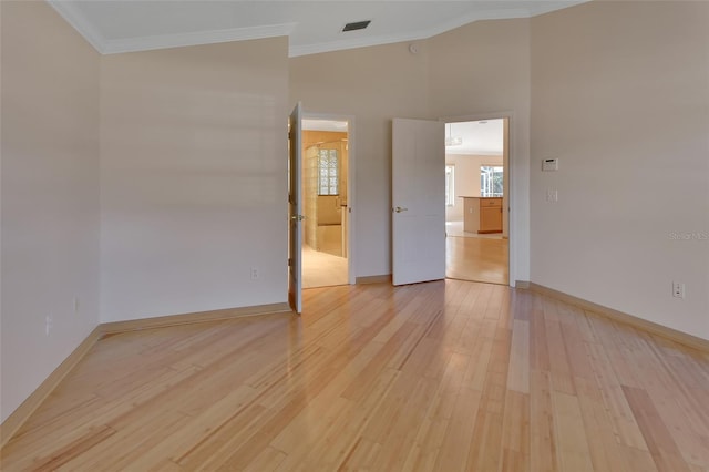 unfurnished room with crown molding and light hardwood / wood-style flooring