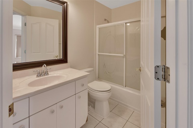 full bathroom featuring vanity, tile patterned floors, shower / bath combination with glass door, and toilet