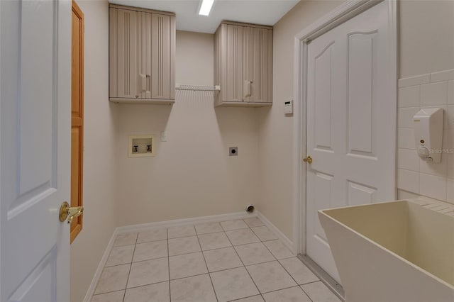 laundry room featuring hookup for a washing machine, electric dryer hookup, light tile patterned floors, and cabinets