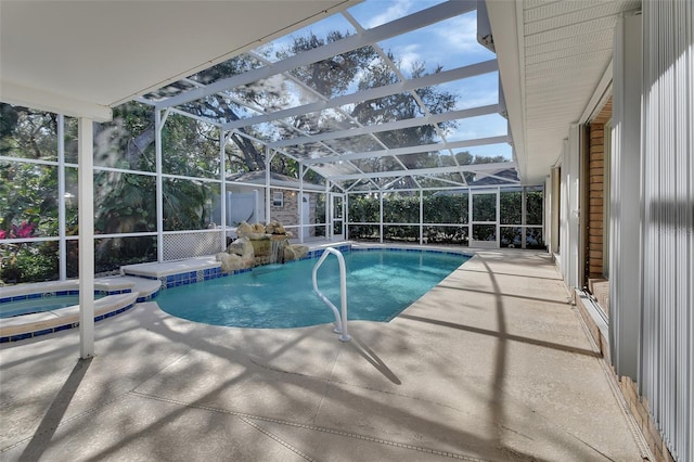 view of pool featuring an in ground hot tub, a patio, and glass enclosure