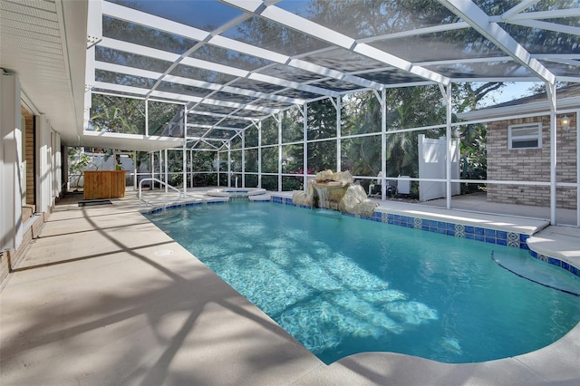 view of swimming pool featuring a patio and glass enclosure