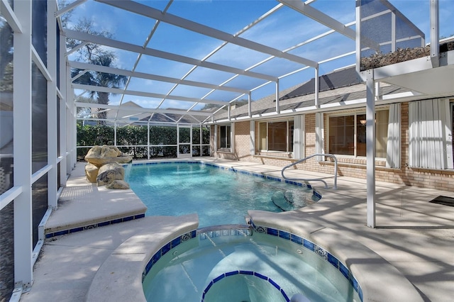 view of pool featuring a patio area, glass enclosure, and an in ground hot tub