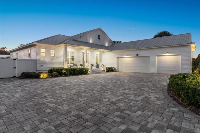 view of front of home featuring a garage and covered porch