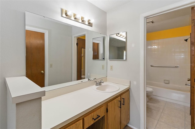 full bathroom featuring vanity, tiled shower / bath, tile patterned floors, and toilet