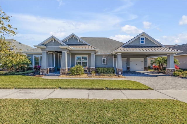 craftsman inspired home with a garage and a front yard