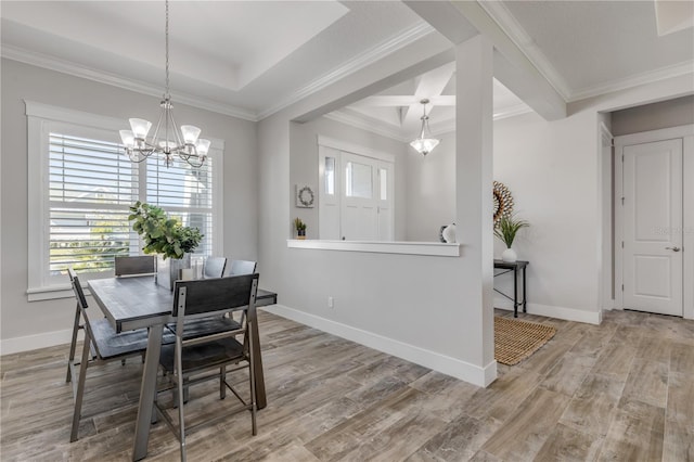 dining space with a notable chandelier, ornamental molding, and hardwood / wood-style floors