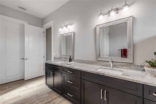 bathroom with vanity and hardwood / wood-style floors