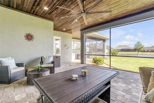 sunroom with wood ceiling and ceiling fan