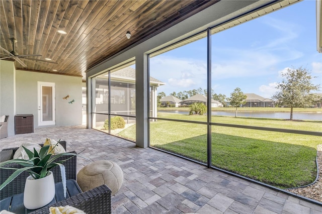 unfurnished sunroom featuring a water view and wood ceiling