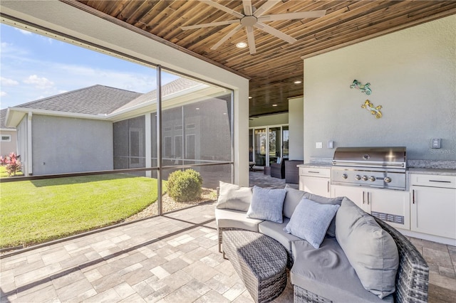 sunroom / solarium featuring wooden ceiling and ceiling fan