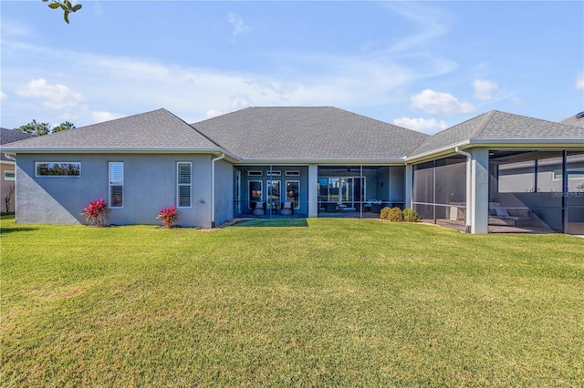 rear view of property with a sunroom and a yard