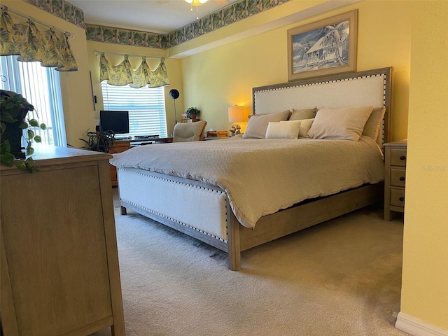 bedroom featuring multiple windows and carpet flooring