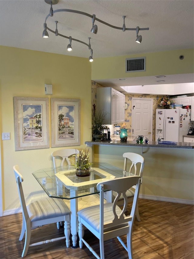 dining room with hardwood / wood-style flooring