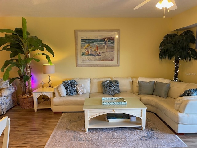 living room with dark wood-type flooring and ceiling fan