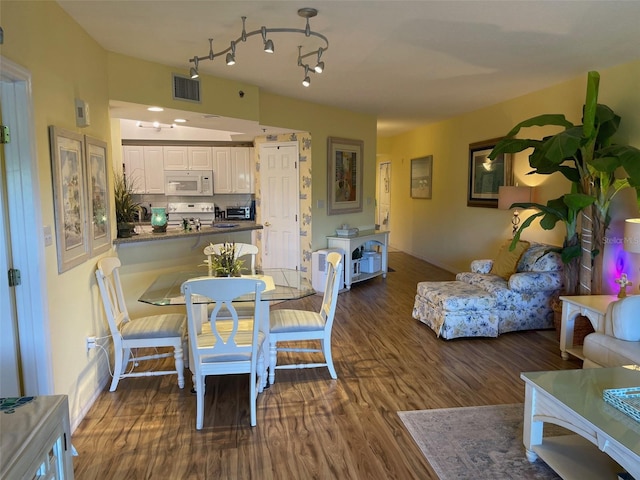 dining area featuring dark hardwood / wood-style flooring