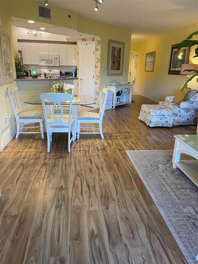 dining room with wood-type flooring