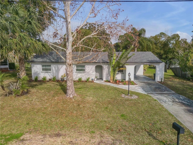 ranch-style home featuring a carport and a front yard