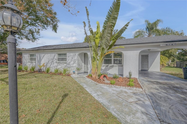 ranch-style home featuring a carport and a front lawn