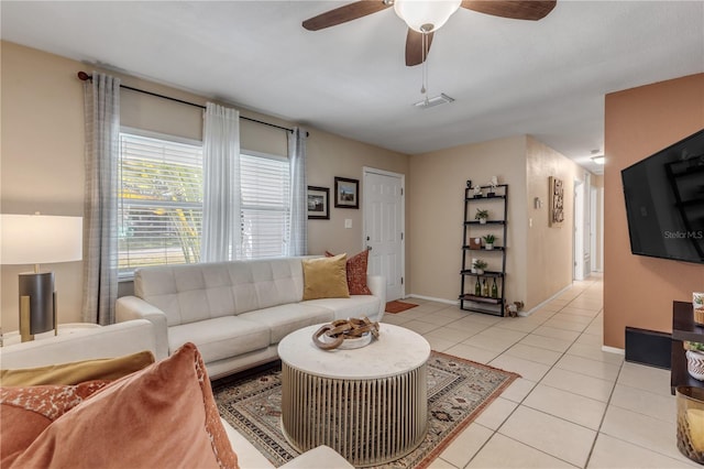 living room with ceiling fan and light tile patterned flooring