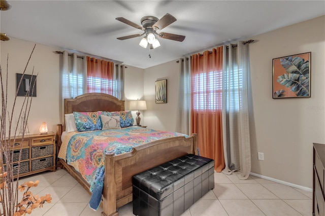 tiled bedroom with multiple windows and ceiling fan