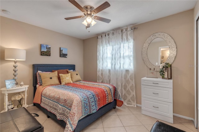 tiled bedroom featuring ceiling fan