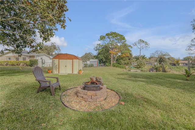 view of yard with a storage shed and a fire pit