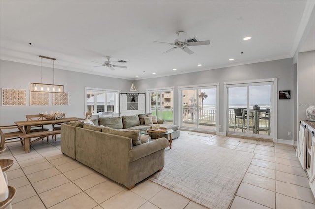 tiled living room with crown molding and ceiling fan