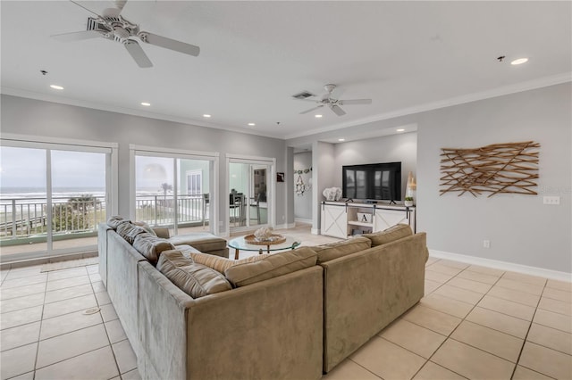 living room featuring light tile patterned floors, ornamental molding, and ceiling fan