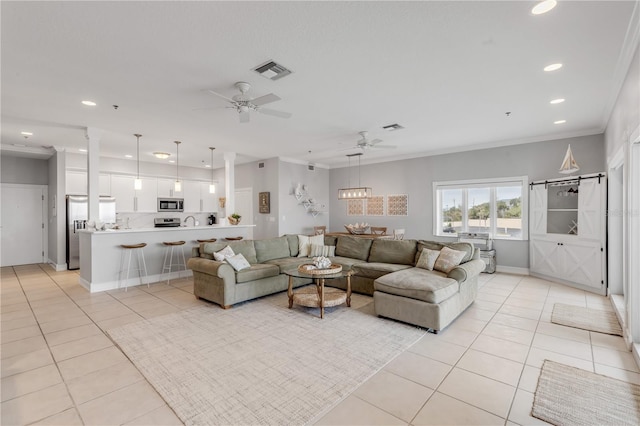 tiled living room with crown molding and ceiling fan