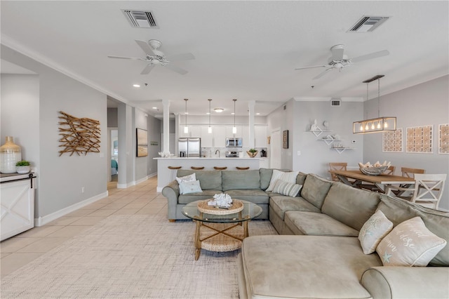 living room featuring light tile patterned flooring, ceiling fan, and ornamental molding