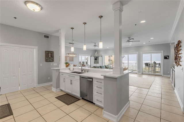 kitchen with sink, ornate columns, stainless steel dishwasher, pendant lighting, and white cabinets