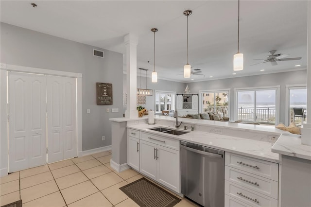 kitchen with pendant lighting, sink, light tile patterned floors, white cabinets, and stainless steel dishwasher