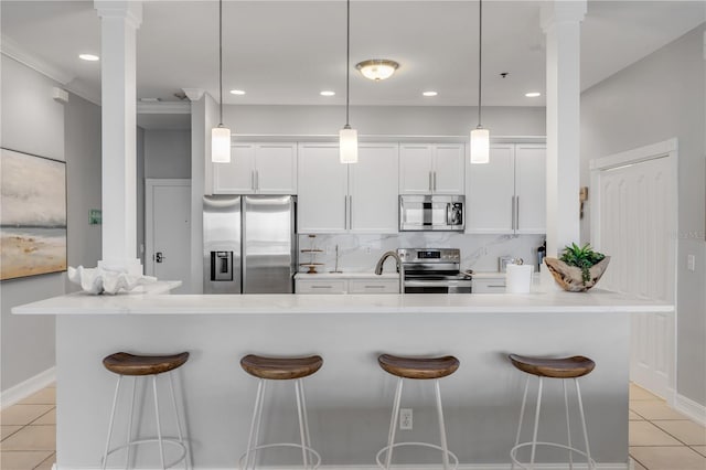 kitchen featuring pendant lighting, appliances with stainless steel finishes, and a large island