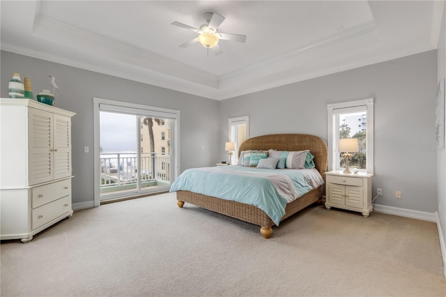 carpeted bedroom featuring access to exterior, ornamental molding, a raised ceiling, and ceiling fan