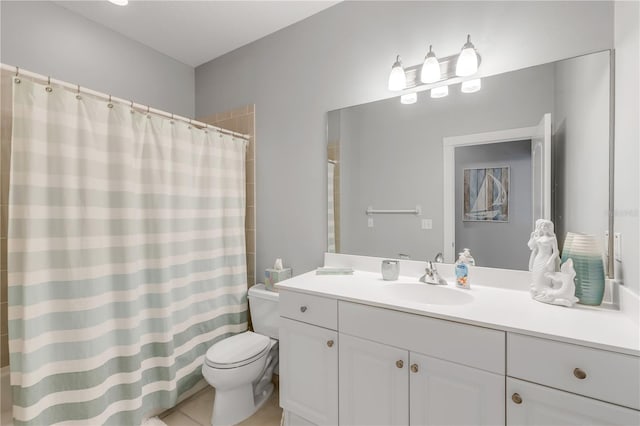 bathroom featuring tile patterned floors, vanity, toilet, and curtained shower