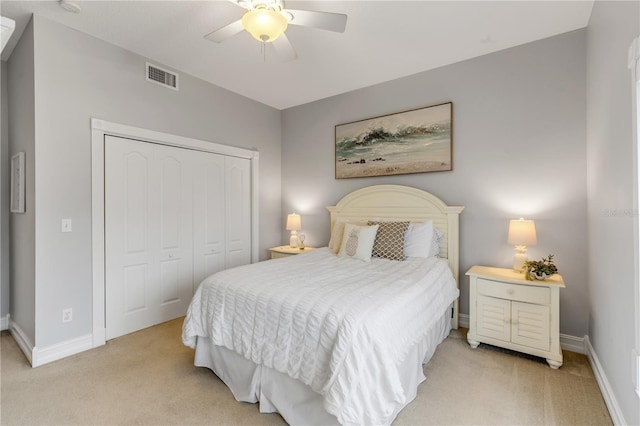 bedroom featuring light carpet, a closet, and ceiling fan