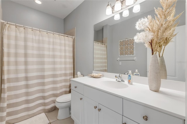 bathroom with vanity, tile patterned floors, and toilet