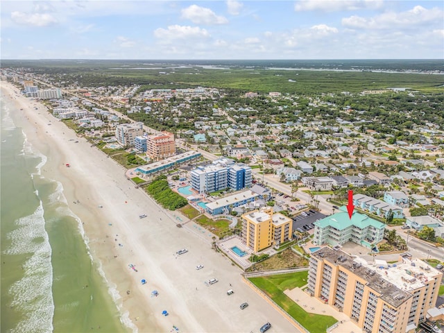 drone / aerial view with a water view and a view of the beach