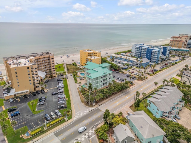 birds eye view of property with a water view and a view of the beach