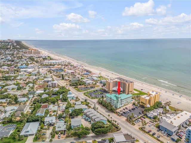 birds eye view of property with a beach view and a water view