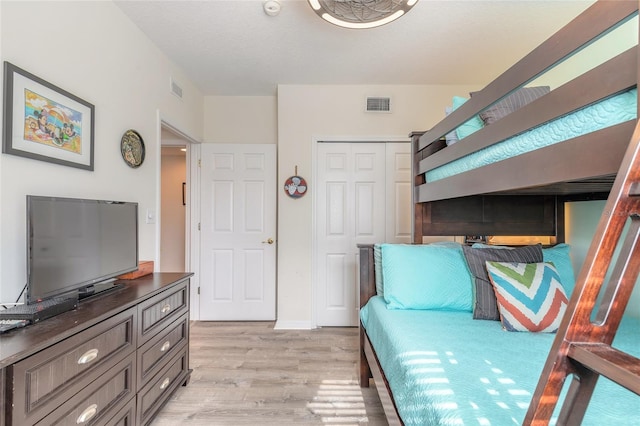 bedroom featuring light hardwood / wood-style flooring and a closet