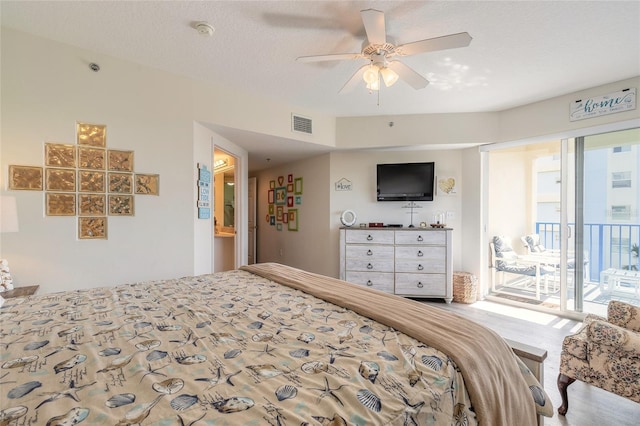 bedroom with access to outside, a textured ceiling, and ceiling fan