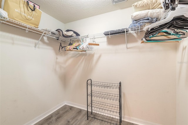 spacious closet featuring hardwood / wood-style floors