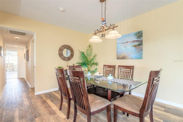 dining area with wood-type flooring