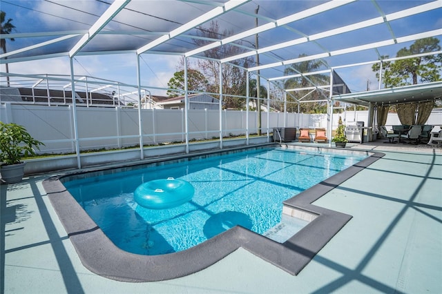 view of swimming pool featuring a lanai and a patio area