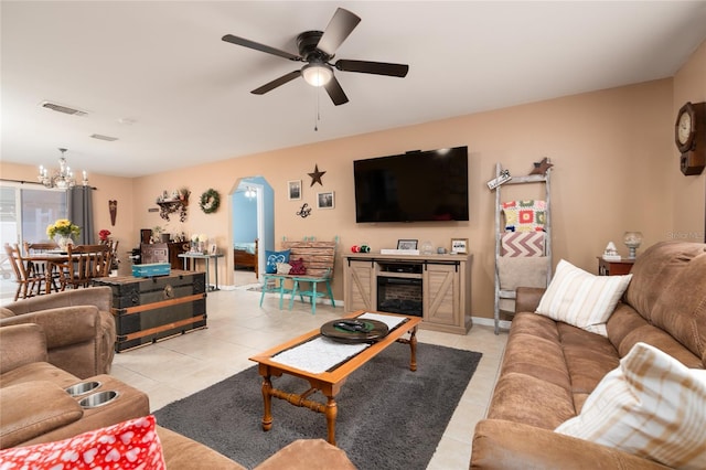 living room with ceiling fan with notable chandelier and light tile patterned floors