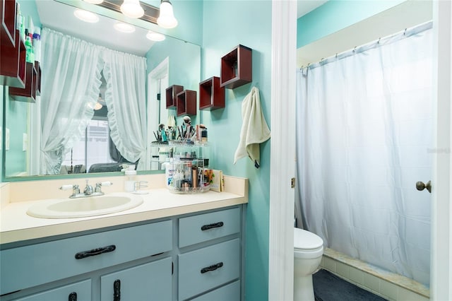 bathroom with vanity, curtained shower, and toilet