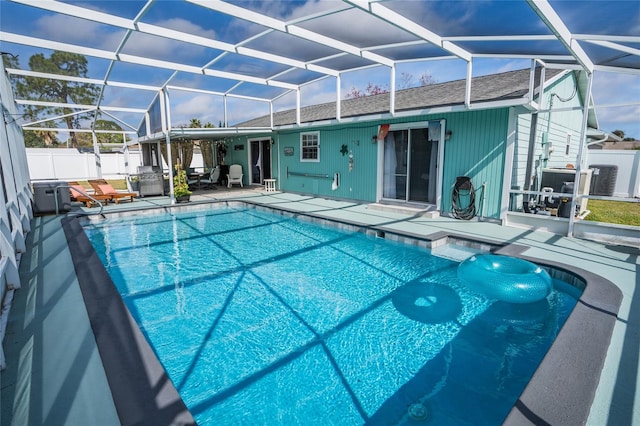 view of pool with a lanai and a patio